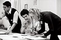 Tuesday nights pass in a blur of activity for medical  students Dhaval Desai and Michael DeVita, left and center, and Shelly Schmoller ’05, x’11, right, who is studying to be  a physician assistant. Before semester’s end, DeVita, one of two clinic coordinators, will help with the transition to new students and coordinators, one of whom will be Desai.