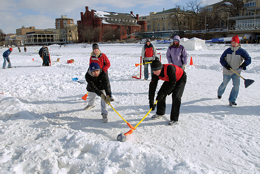 Students play broomball on a cleared section of frozen Lake Mendota. Played like ice hockey (only without skates or, well, rules) broomball has been a popular intramural sport among UW students for decades. This photo was taken during the 2007 Hoofers Winter Carnival. Photo: Jeff Miller