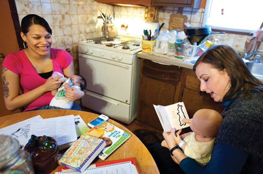 Melissa Rader, a public-health nurse, holds a baby doll to demonstrate how best to read books to an infant. Photo: Jeff Miller