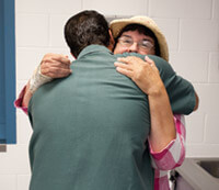 Jackie Millar hugs Craig Sussek at the start of their meeting