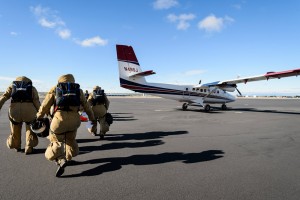 Suited up and ready to go, members of the Great Basin Smokejumpers board a Twin Otter airplane as they prepare for a practice jump.
