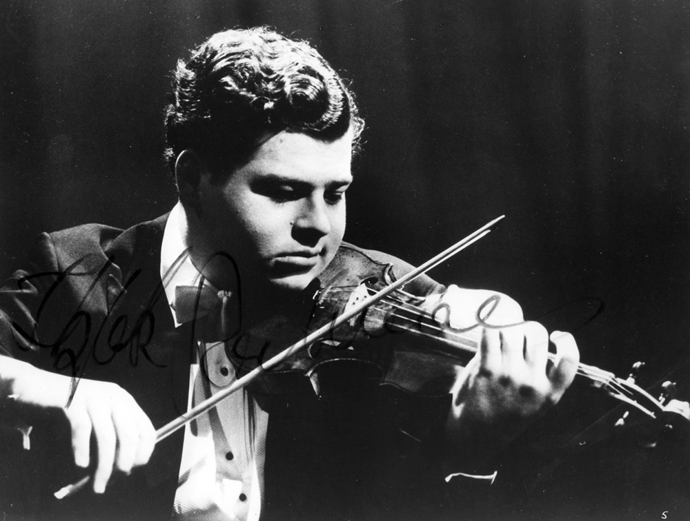Black and white photo of a young Itzhak Perlman playing violin.