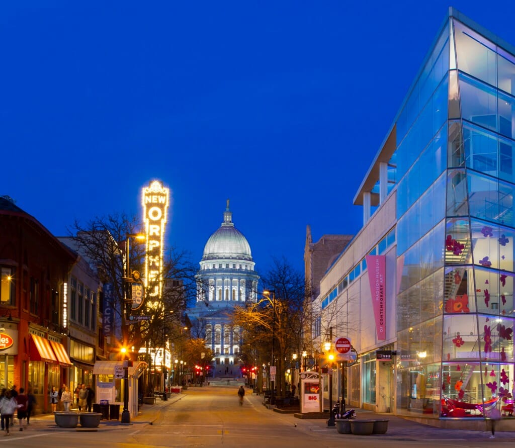 Nighttime view of the capitol building and State Street in Madison, WI.
