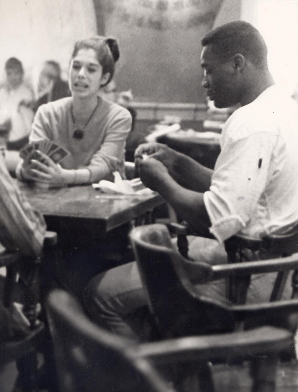 Historical black and white photo of students playing cards in the Memorial Union
