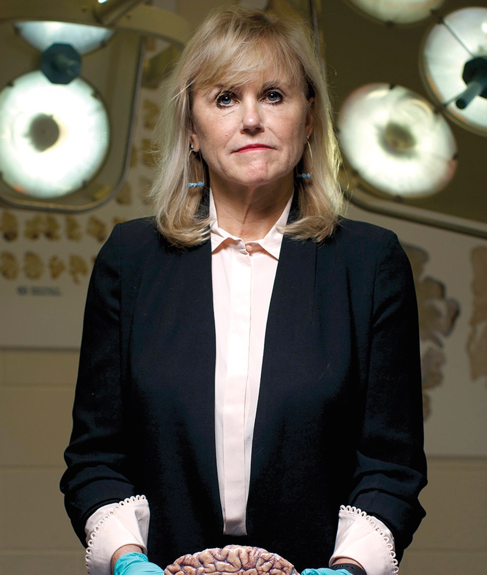 Ann McKee holding cross-section of human brain