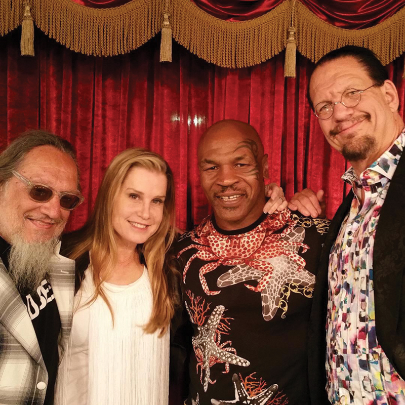 Sloman poses with Emily Jillette, boxer Mike Tyson, and magician Penn Jillette. Sloman collaborated on an autobiography and a memoir with Tyson. 