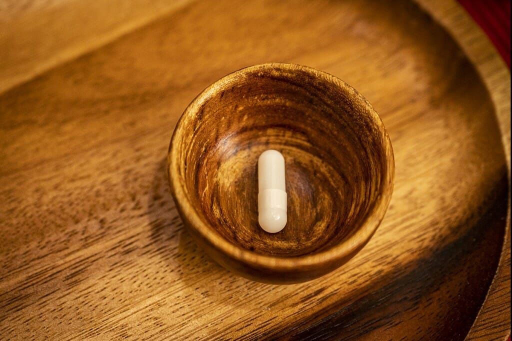 A pill capsule in a dish