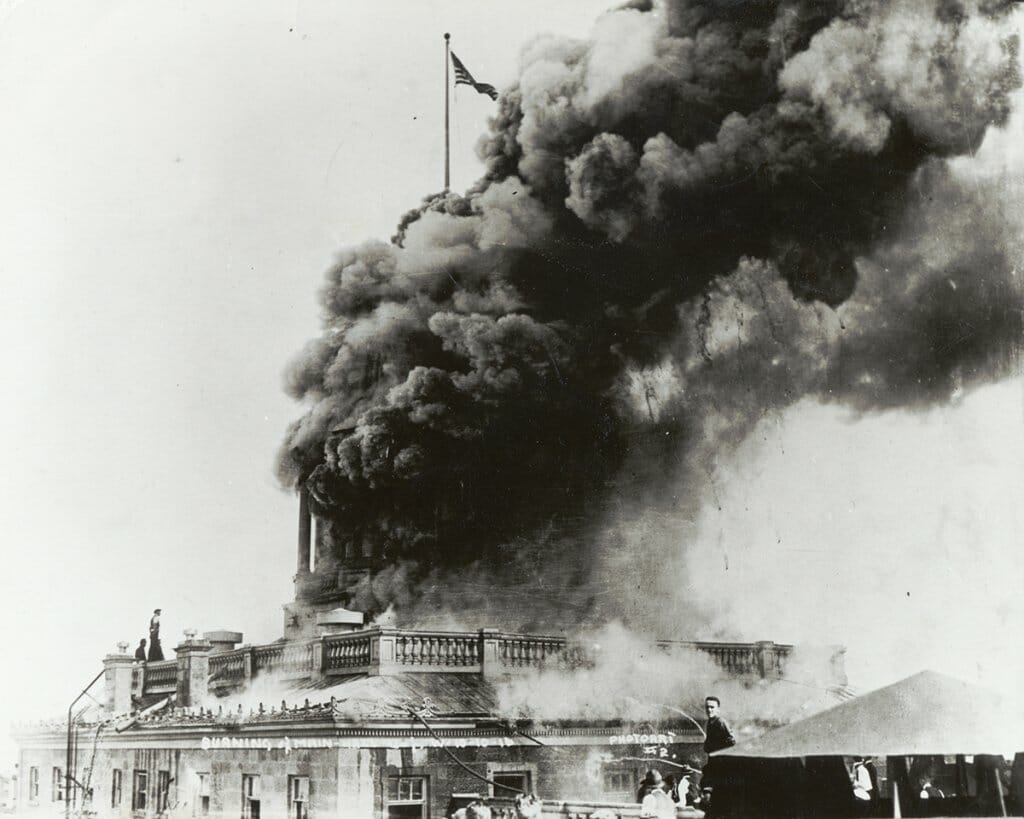 Archival black and white photo of Bascom Hall fire showing black smoke billowing out from the former dome