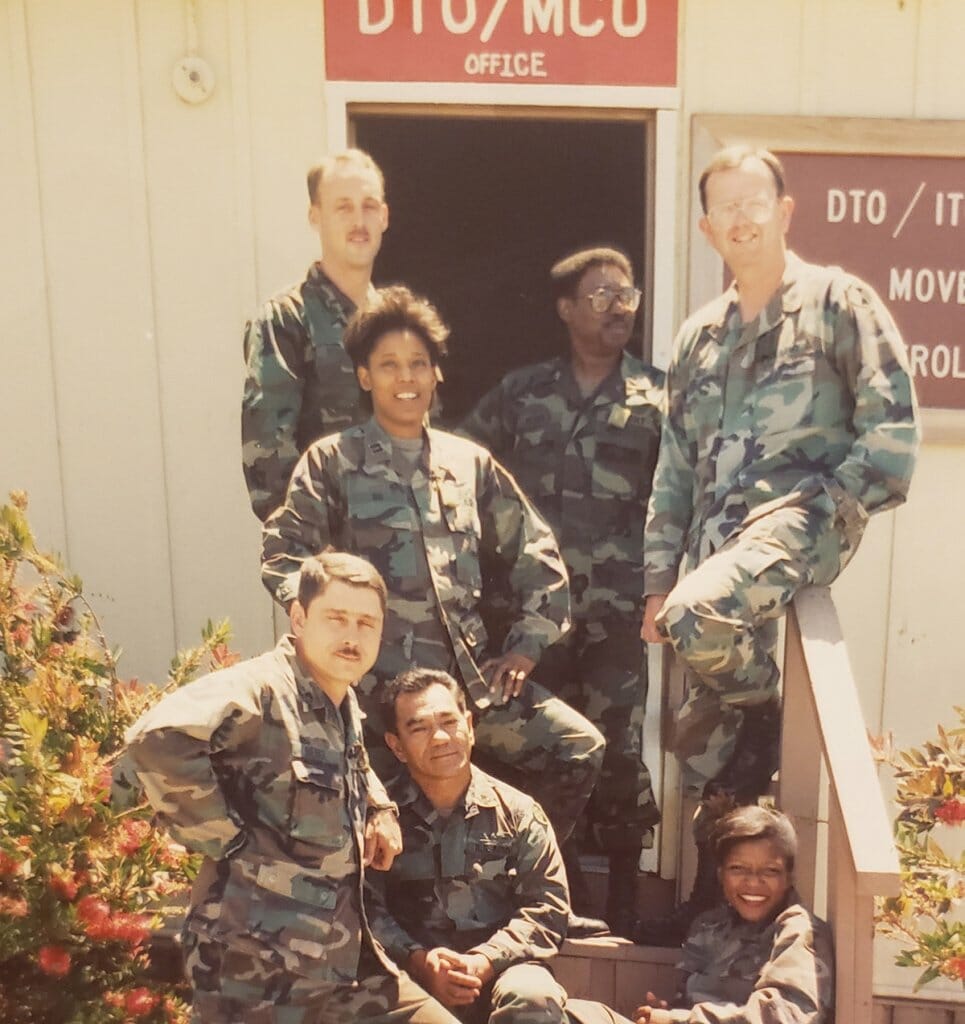 Faded 1989 photo of Marcella Ng and fellow members of the military in fatigues