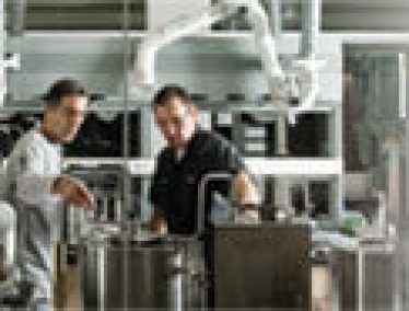 Brewing consultant Joe Pulizzano (left) looks over the UW’s new pilot-scale brewing equipment with faculty associate Jon Roll. Though mostly used for instruction and research, the equipment also produced a batch of Bucky’s Inaugural Ale (right), a light, golden ale. Photos: Bryce Richter.