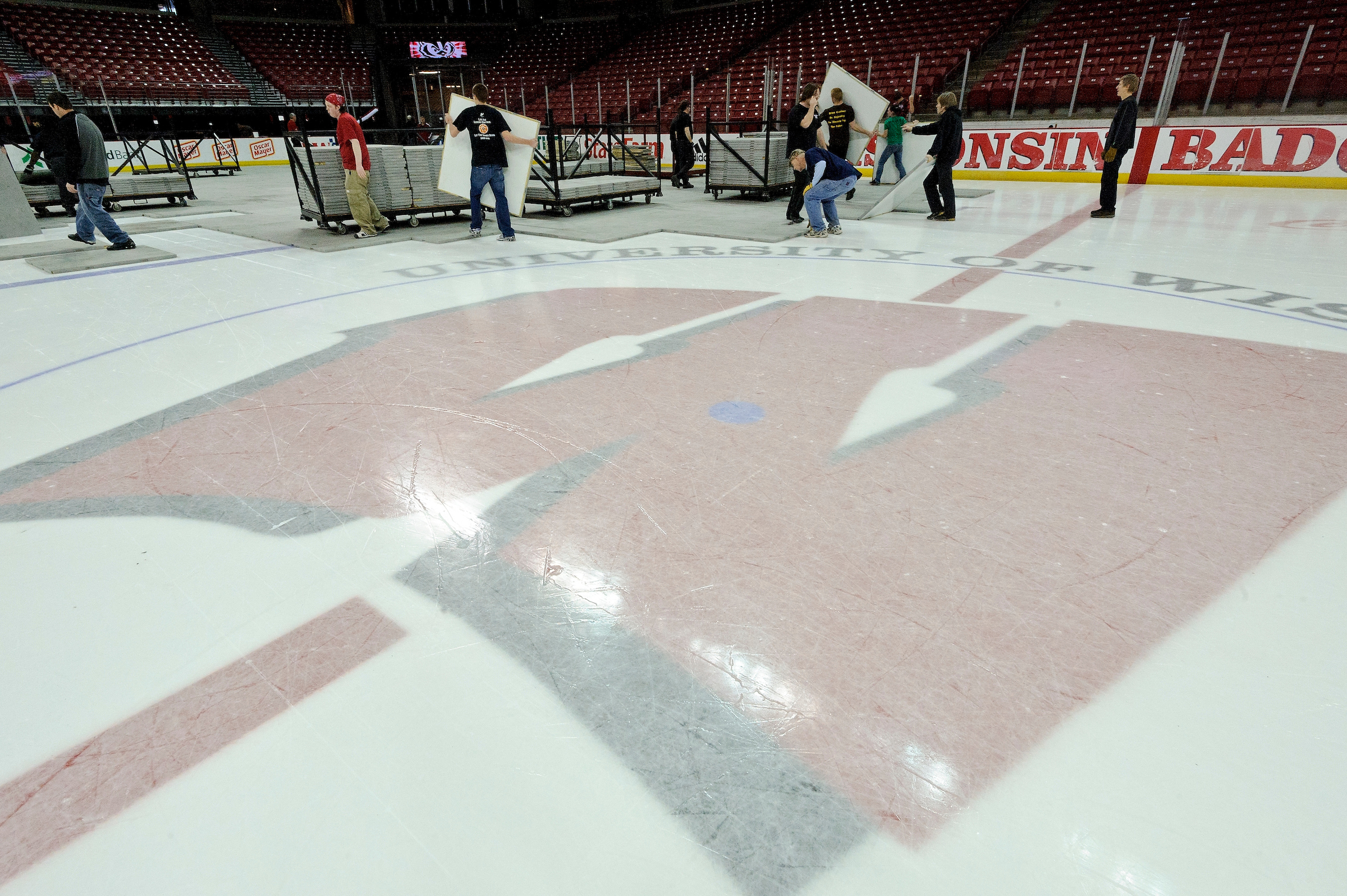 Workers remove the basketball court, revealing the ice underneath