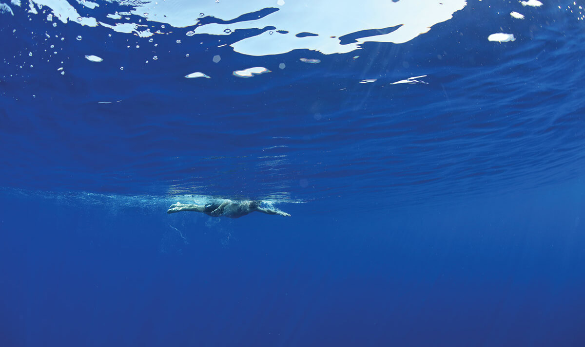 Andy Moore swimming in the Pacific Ocean off Hawaii