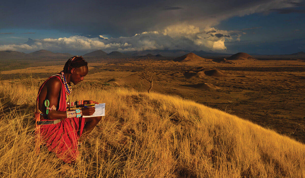 A Masai warrior fills out a form