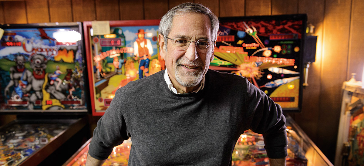 Roger Sharpe standing in front of some pinball machines