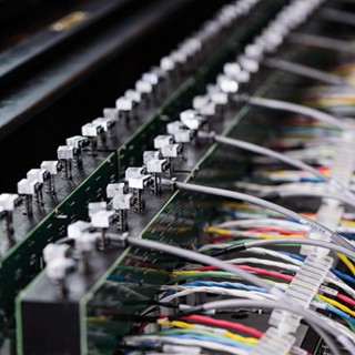 Christopher Taylor shows off the internal workings of the hyperpiano. The electronics inside the double- keyboard console connect to two separate pianos.