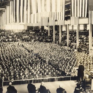 UW President Charles Van Hise gives a convocation address titled “What Does War Mean to Me?” before a capacity crowd at the Stock Pavilion in April 1917. <span class=