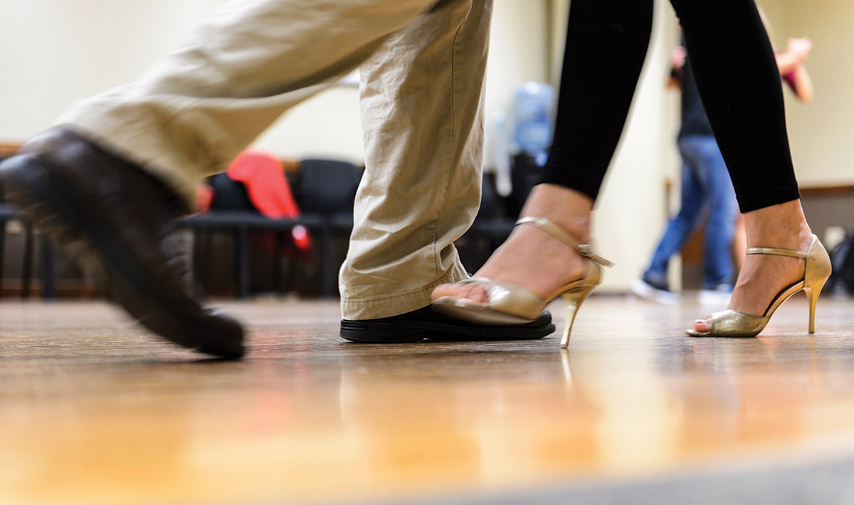 Close-up shot of the feet of a man and woman dancing.