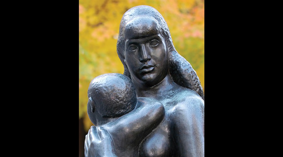 Statue of holding small child to her chest.
