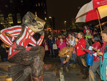 Crowd admires life-sized statue of Bucky Badger.