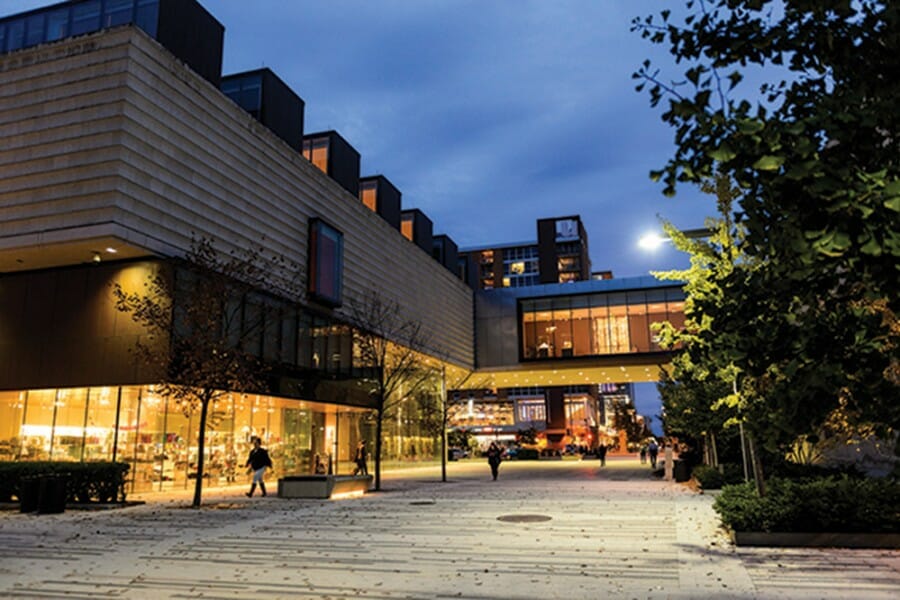 Pedestrians walk along East Campus Mall past the Chazen Museum of Art at the University of Wisconsin-Madison during autumn on Oct. 28, 2016.