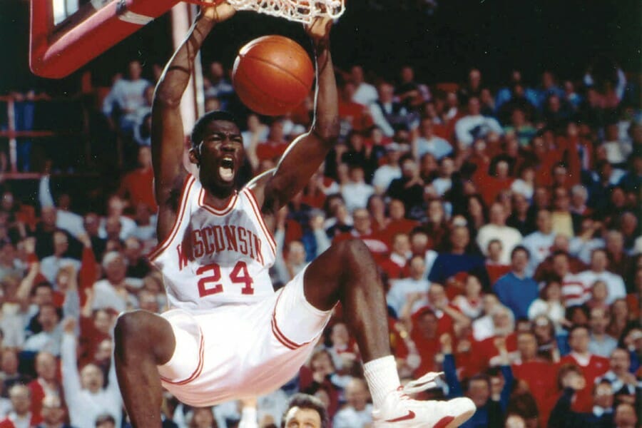 Michael Finley dunks a basketball during a Badger game.