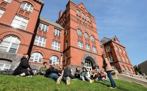 Students lounge on the grass outside of Science Hall at UW-Madison