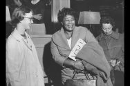 Black and white photo of Ella Fitzgerald with two students.