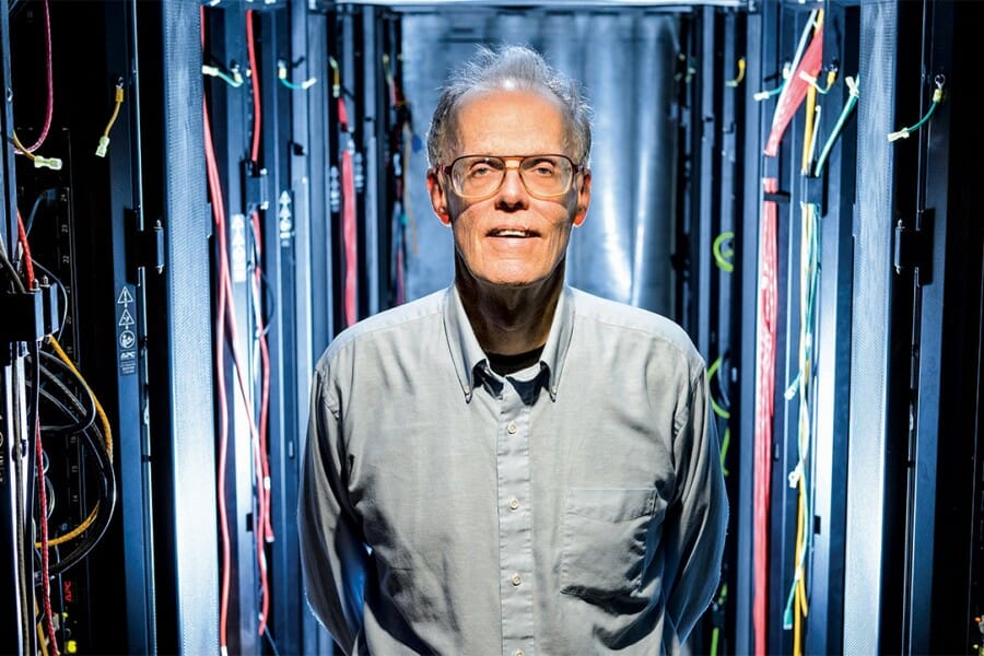 Bill Hibbard stands in server room