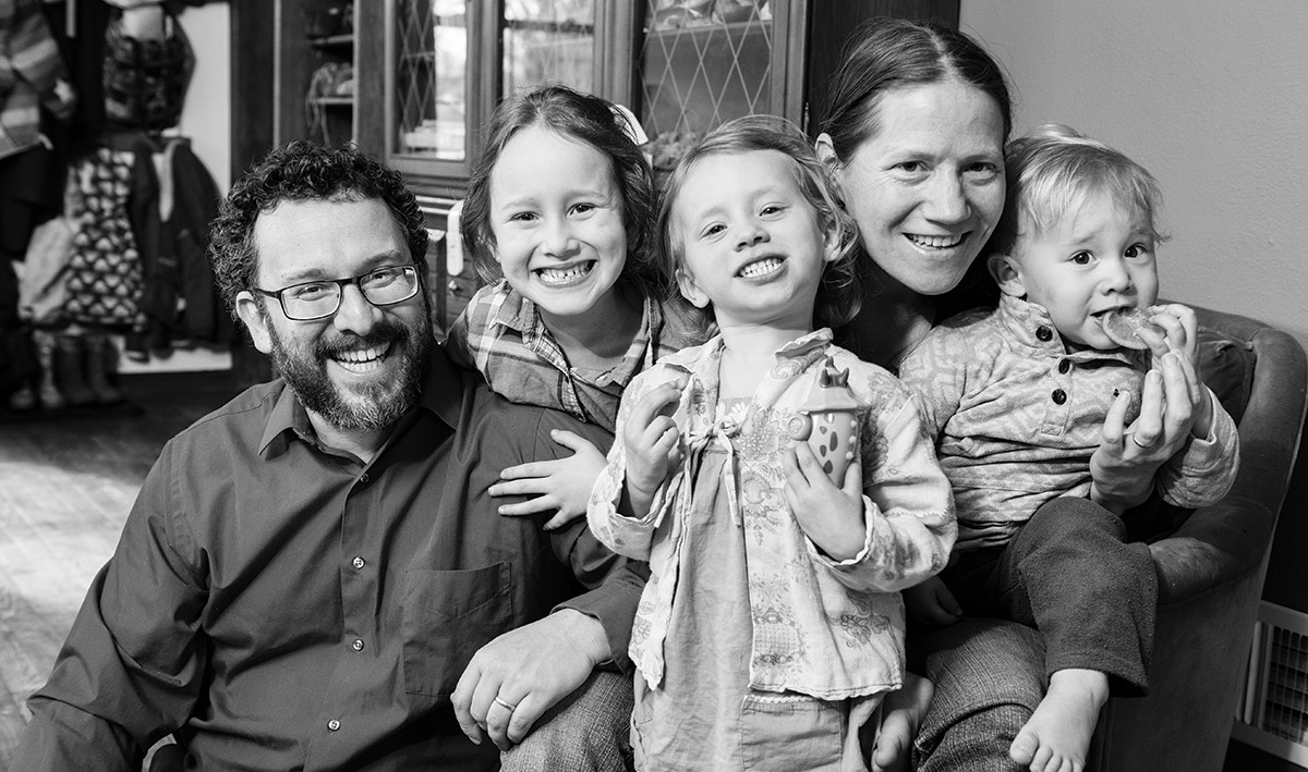 Dan and Iris Levitis pose with their three young children