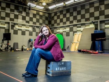 Rachel Rose sits on crate in production room at Industrial Light and Magic studio