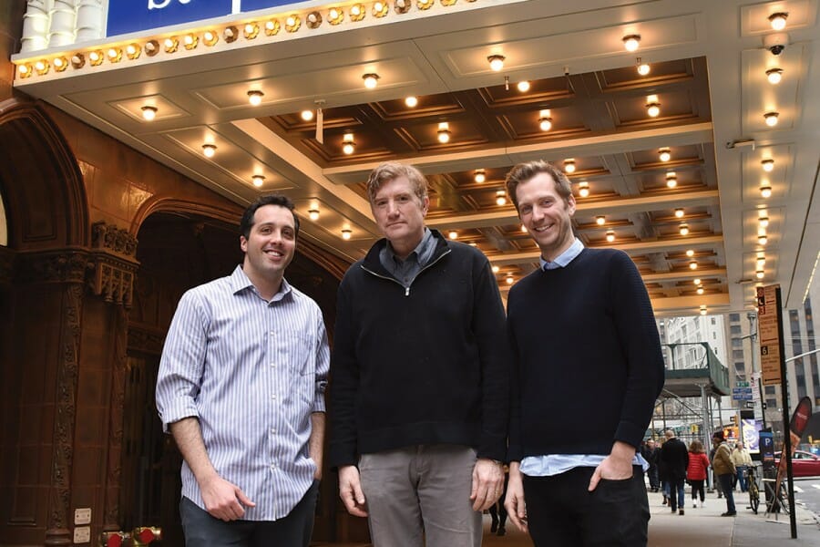 Brian Stack stands with Aaron Cohen and Gabe Gronli, outside a theater with a sign for the Late Show on its marquee