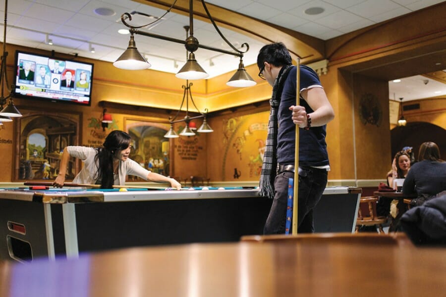 Two students play pool in the Memorial Union Der Stiftskeller