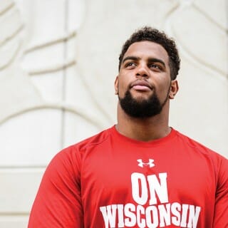 Portrait of Bryson Williams wearing a red shirt printed with words 