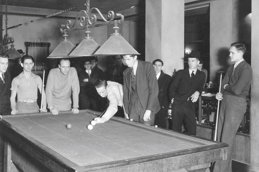 Black and white photo from the 1930s of students playing pool