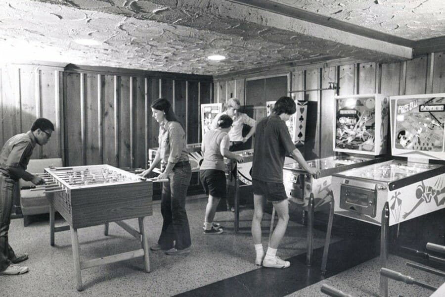 Black and white photo from the 1970s of students playing foosball