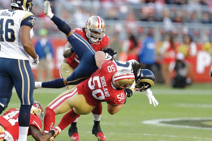 Chris Borland being tackled during football game