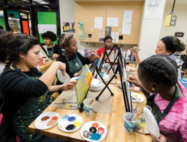 Students paint canvases in the Wheelhouse Studios at UW–Madison