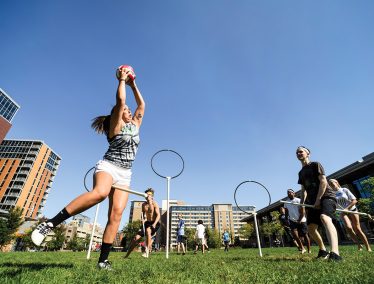 Alison Pujanauski has the ball during a game of Quidditch with fellow students
