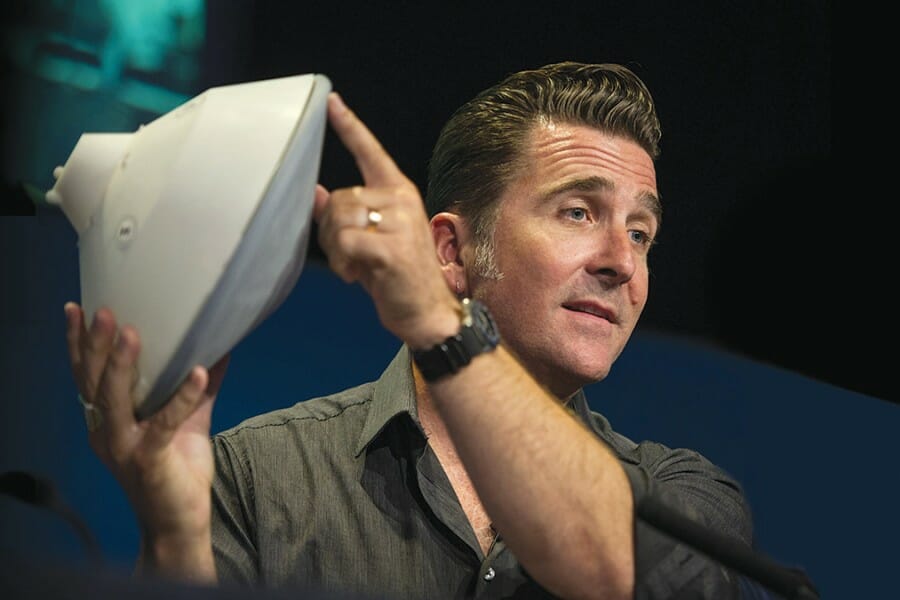 Adam Steltzner holds a model of the Mars entry capsule