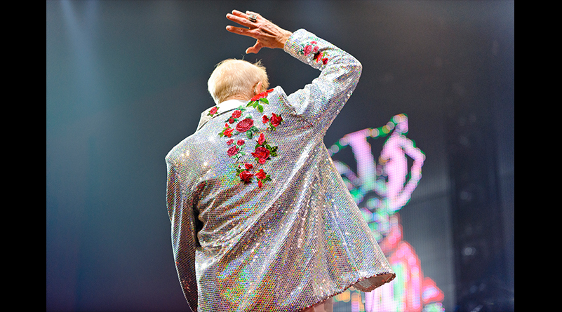 Mike Leckrone with his back to the camera wearing sequined jacket