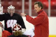 Head coach Mark Johnson gives directions to members of the Wisconsin Badgers women's hockey team at the Kohl Center at the University of Wisconsin-Madison