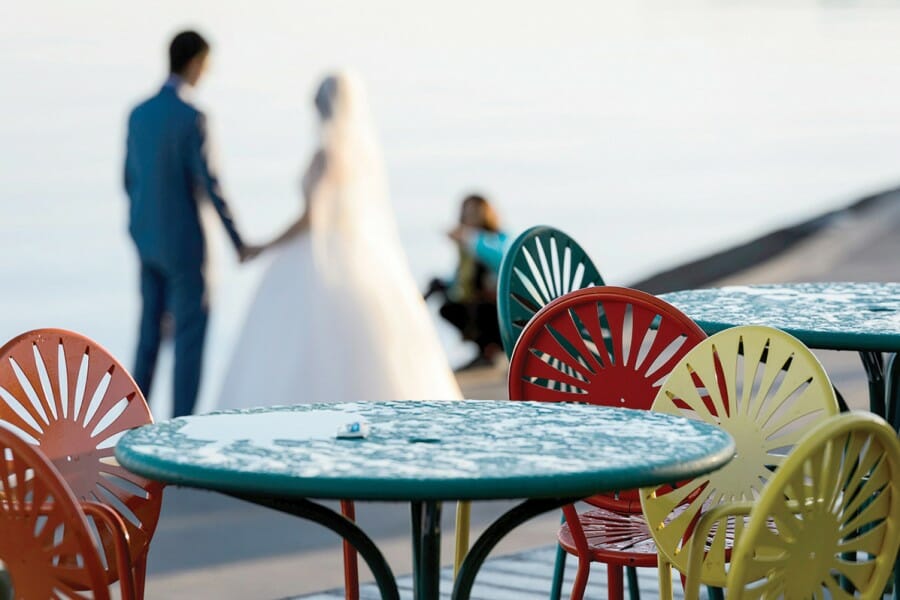 A bride and groom pose for photographs at the Memorial Union Terrace