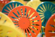 Close-up of yellow, green, and orange sunburst chairs at the Un