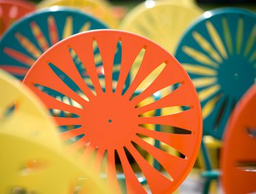 Close-up of yellow, green, and orange sunburst chairs at the Un