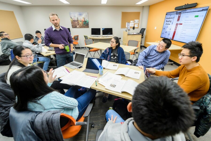 Students gathered around a table during a class in Helen C. White hall