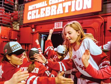UW women's hockey team high-five fans