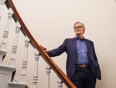David Blight poses on staircase