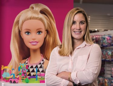 Erin Strepy in front of poster of Barbie