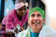 A child cancer patient spray paints David Margolis' hair green