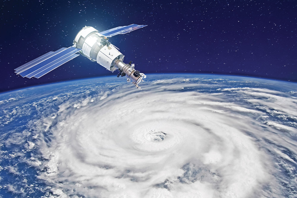Stock image of a satellite above a hurricane on Earth's surface
